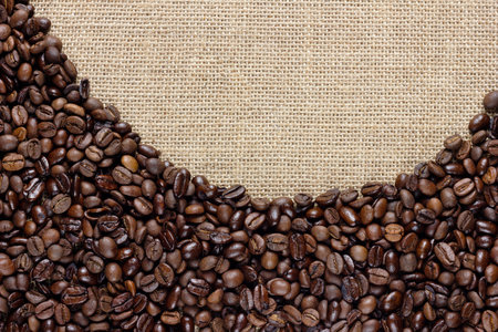 Border of coffee beans on the old burlapの写真素材