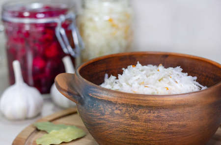Homemade Sauerkraut with Carrot and Salad Cabbage with Beetroot on a wooden table. Fermented food.の写真素材