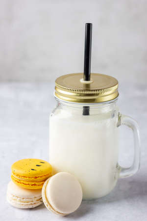 Colored macaroons with milk in mason jar.の写真素材