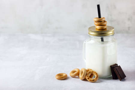 Baked bagels, chocolate and milk in mason jar.の写真素材