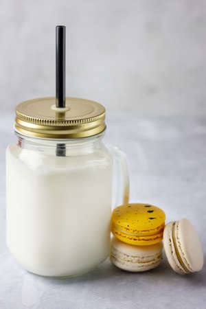 Colored macaroons with milk in mason jar.の写真素材