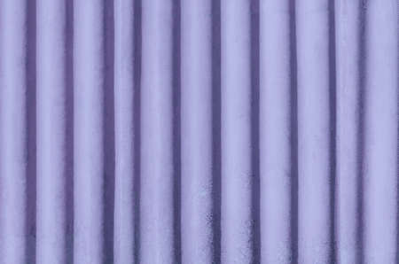 Lilac vintage rugged metal corrugated iron fence. Trendy color of the year 2022 Very Peri. Background for your designの写真素材