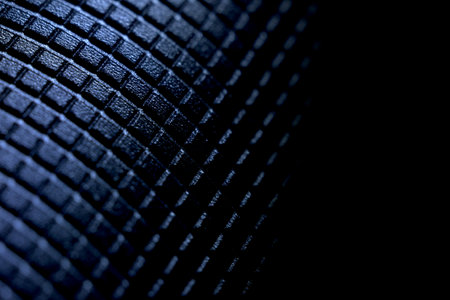 Geometric pattern on a metal surface with a distinct texture in shades of black and blue.