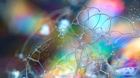 Soap bubbles with colored patterns on the surface in macro. Details and reflections on the soap bubbles in close-up.の写真素材