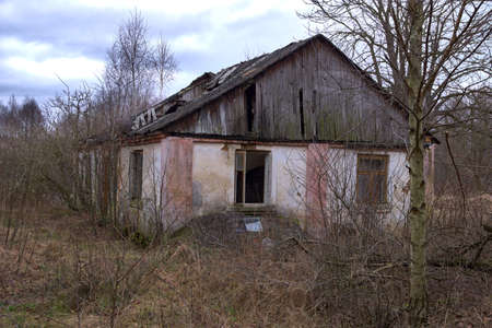 Old abandoned house. Ruined building with collapsing roof.
