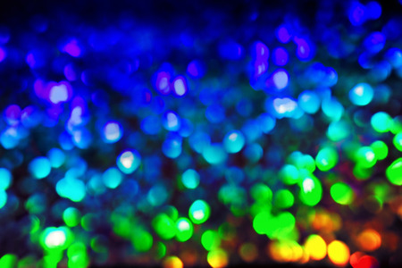 Bokeh glittering shine bulbs lights background:blur of Christmas wallpaper decorations concept.holiday festival backdrop:sparkle circle lit celebrations displayの写真素材