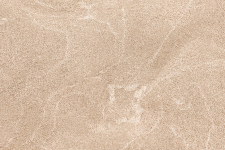 A top down shot of a dry river beige sand bottom full of texture and salt marks. Useful as abstract background.の写真素材