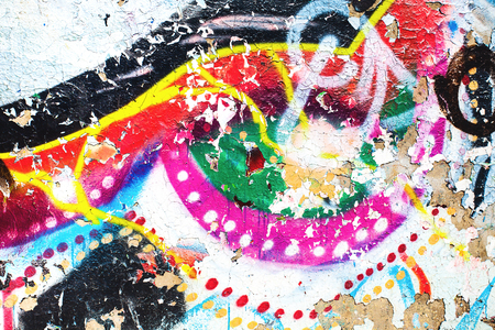 Closeup of texture damaged colorful graffiti wallの写真素材