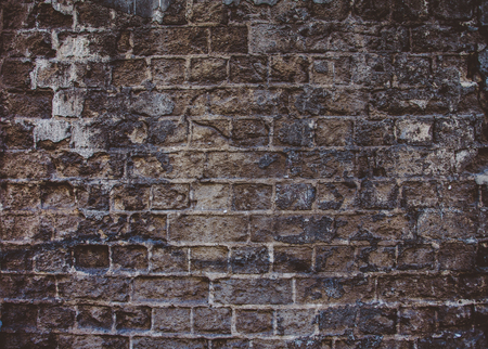 Closeup of old grey and rough dark sandstone wall. For pattern, texture and backgroundの写真素材