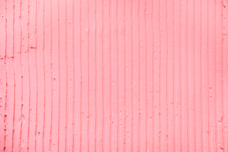 Closeup of the wall with a decorative pink colored plaster vertical lines and stripes. Textured concrete wall with as a texture or background. Pastel color, design concept.の写真素材