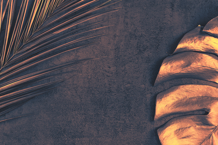 Closeup of bronze palm and monstera leaves on abstract dark purple textured background. Tropical conceptual elegant trendy toned summer background. Flat lay. Copy space.の写真素材