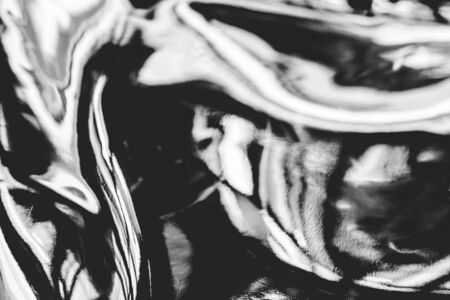 Abstract black and white fluid art background. Real holographic metallic foil texture with scratches and irregularities.の写真素材