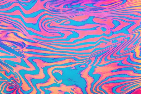 Abstract trendy neon colored psychedelic fluorescent striped zebra textured background.の写真素材