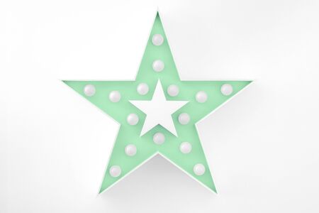 Large trendy mint colored decorative star with lots of lights on white background. Beautiful decor, modern design element.の写真素材