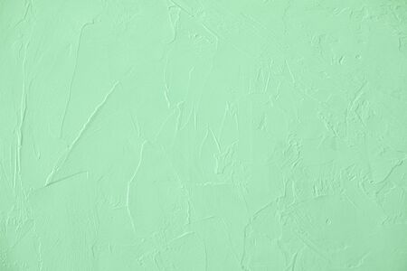 Trendy mint colored low contrast Concrete textured background with roughness and irregularities to...