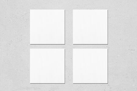 Four empty white square business card mock ups with soft shadows on neutral light grey concrete background. Flat lay, top viewの写真素材
