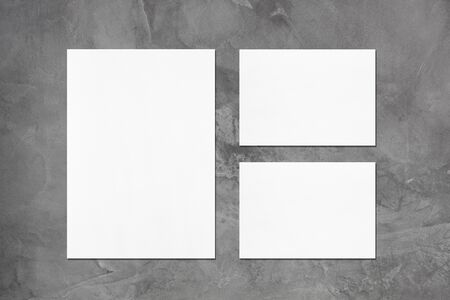 One empty white vertical a4 sized poster and two a5 sized horizontal rectangle card mockups with...