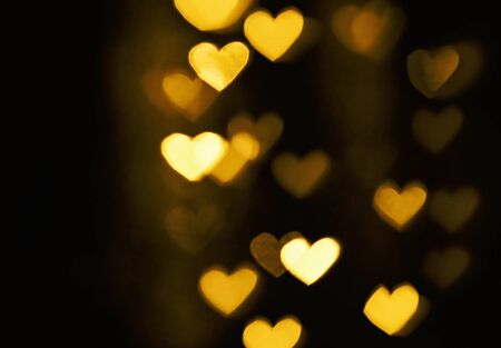 Festive overlay effect. Golden heart bokeh festive glitter background.の写真素材