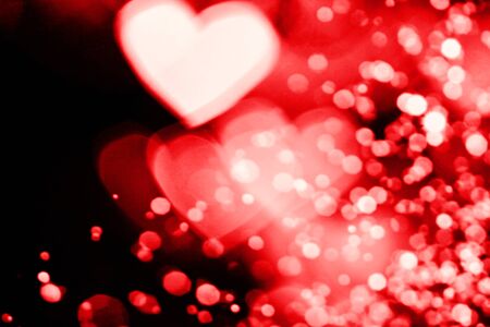 Festive overlay effect. Red and pink heart bokeh festive glitter background. Christmas, New Year and Valentine's day design.の写真素材