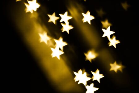 Festive overlay effect. Golden stars bokeh festive glitter background. Christmas, New Year and Valentine's day designの写真素材