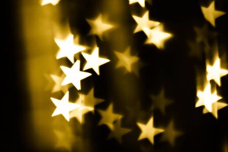Festive overlay effect. Golden stars bokeh festive glitter background. Christmas, New Year and...