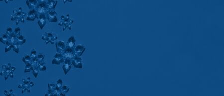 Banner with Clear glass snowflakes on dark blue background. Minimal christmas concept. Open composition. Copy space. Year color trend 2020.の写真素材