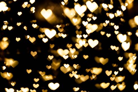 Festive overlay effect. Golden heart bokeh festive glitter background. Christmas, New Year and...