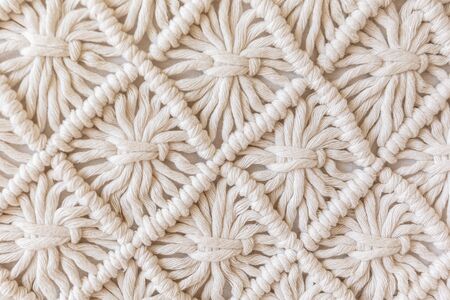 Close-up of hand made macrame texture pattern. ECO friendly modern knitting DIY natural decoration...