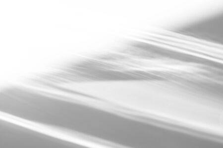 Overlay effect for photo and mockups. Organic drop diagonal shadow and rays of light from window on a white wall. shadows for natural light effectsの写真素材