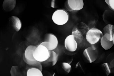 Black and white circles bokeh festive glitter dark backgroundの写真素材