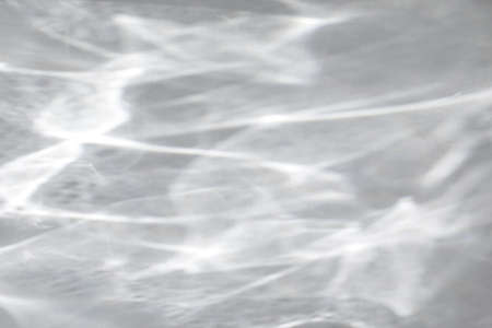 shadow and light caustic effect on a white wall