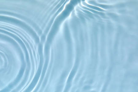 transparent blue colored clear calm water surface textureの写真素材