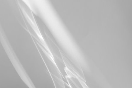 shadow and light caustic effect on a white wallの写真素材