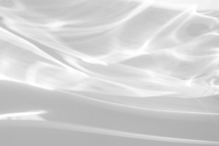 shadow and light caustic effect on a white wallの写真素材