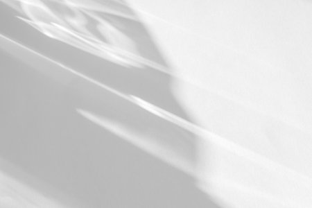 shadow and light caustic effect on a white wallの写真素材