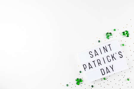 Lightbox with Saint Patricks day text and shamrocks made of green glass heartsの写真素材