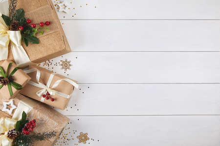 Border of gift boxes wrapped in kraft paper on white wood desk backgroundの写真素材