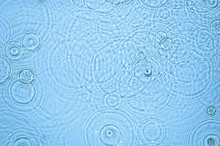 transparent blue colored clear calm water surface textureの写真素材