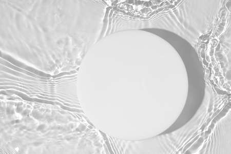 Empty white circle podium on transparent clear water background with copy spaceの写真素材