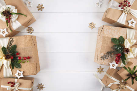 Borders of gift boxes wrapped in kraft paper on white wood desk backgroundの写真素材