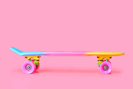 rainbow plastic Penny board skateboard isolated on pink backgroundの写真素材