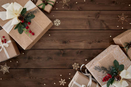 Christmas background with borders of gift boxes on dark brown wood backgroundの写真素材