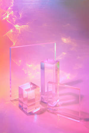 two clear glass rectangle prism podiums on pastel neon background