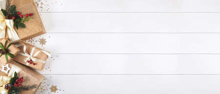 Christmas banner with border of gift boxes on white wood backgroundの写真素材