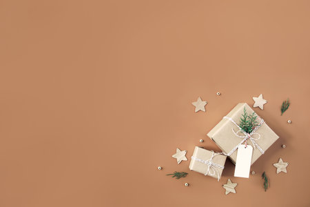 small Christmas gift boxes on beige backgroundの写真素材