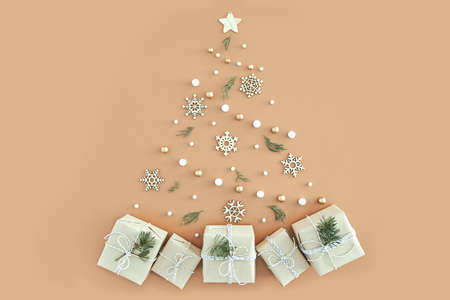 Christmas tree made of small gifts on beige background