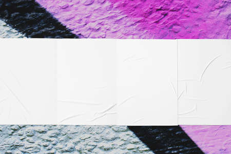colorful urban wall texture with four wrinkled glued poster templates