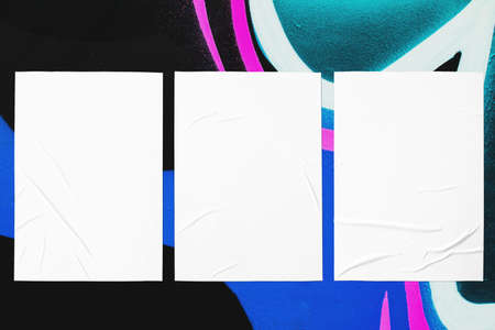 colorful urban wall texture with three wrinkled glued poster templatesの写真素材