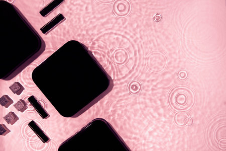 Abstract black geometric figures composition on transparent pink clear waterの写真素材