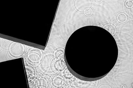 Abstract black geometric figures composition on transparent clear waterの写真素材